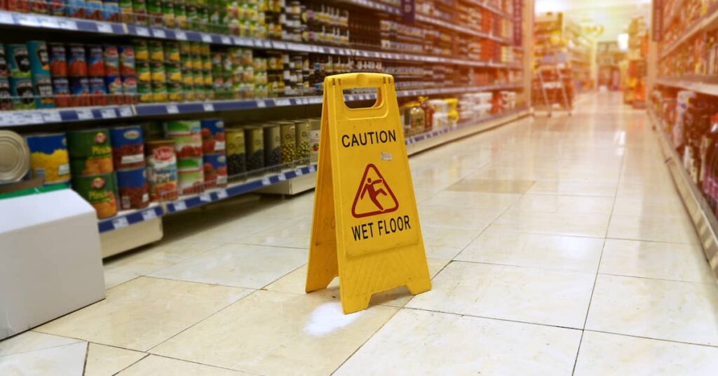 a wet floor sign in a grocery aisle | Morris, Andrews, Talmadge and Driggers, LLC