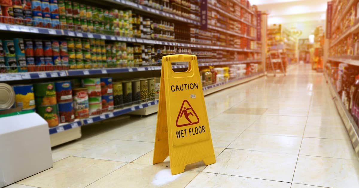 wet floor sign in grocery aisle | Morris, Andrews, Talmadge and Driggers, LLC