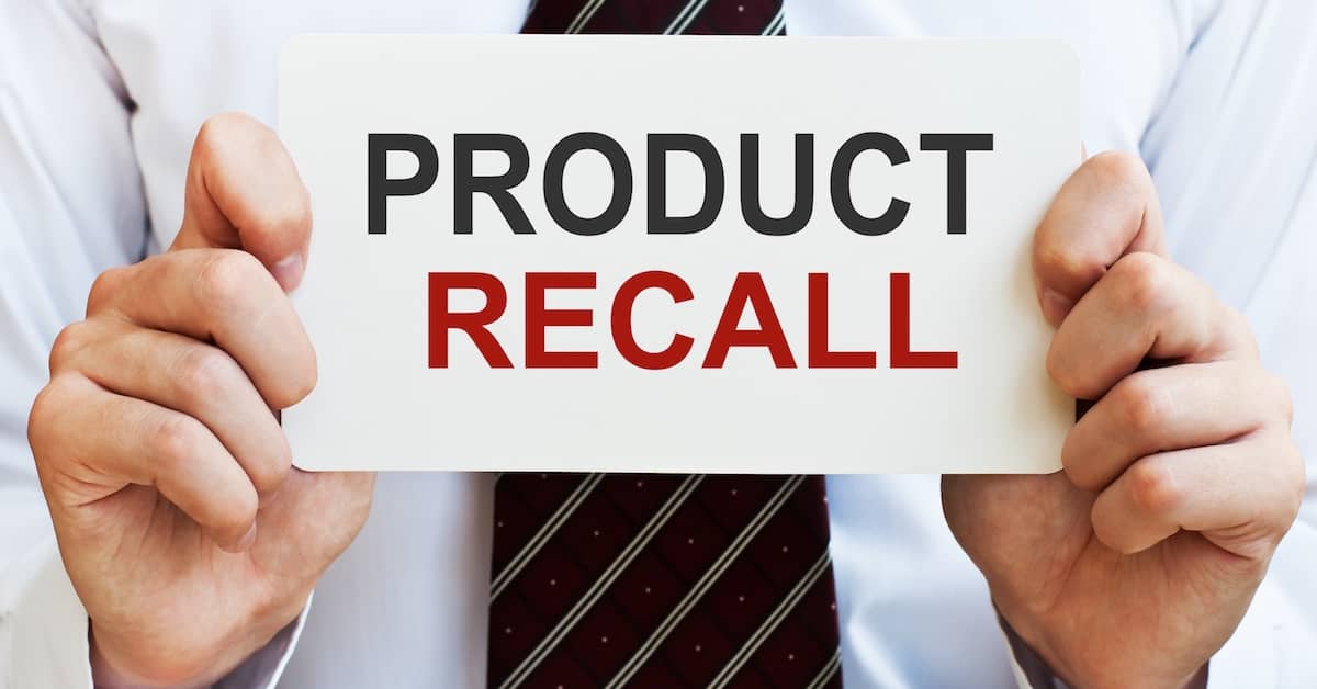 Product recall sign held by lawyer.